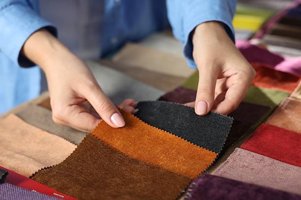 istock Woman choosing fabric among different samples indoors, closeup 2245349085