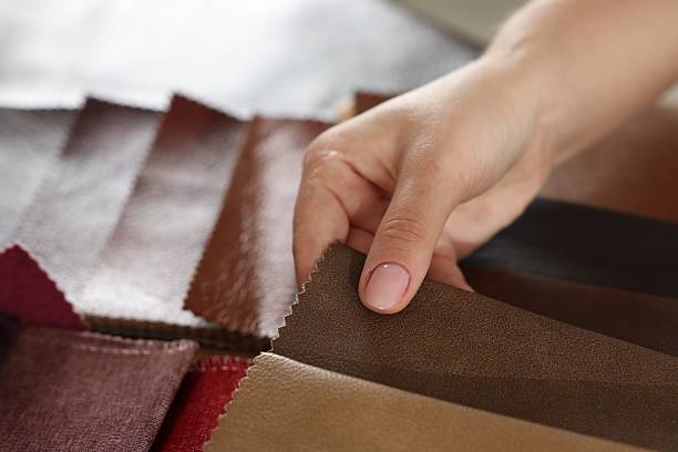 istock Woman choosing fabric among different samples indoors, closeup 2245349100