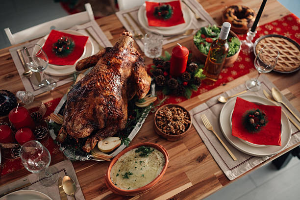 istock Christmas dinner table setting with roasted turkey and festive decorations 2245350572