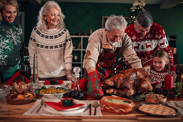 istock Family enjoying christmas dinner with roasted turkey 2245350601
