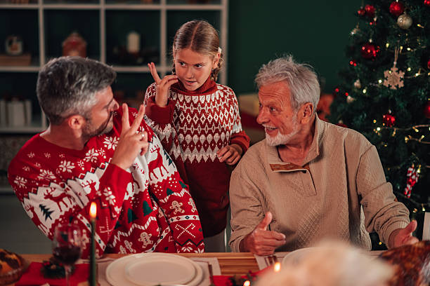 istock Family wearing christmas sweaters having fun at christmas dinner 2245350672