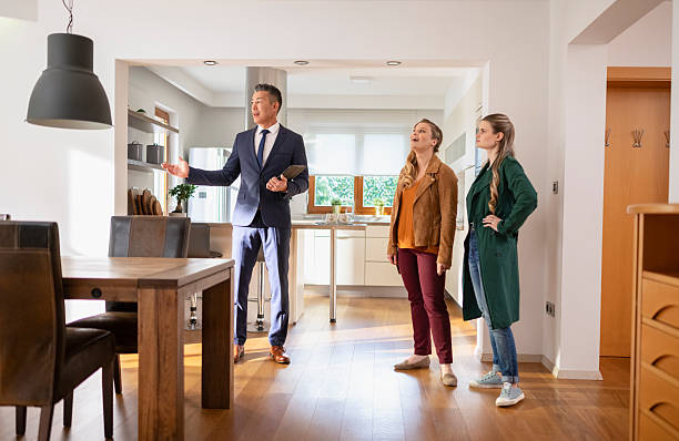 istock Real estate agent showing house to customers 2245351147