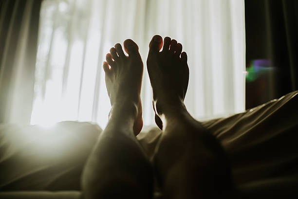 Point of view of a person relaxing at home with feet up on the sofa.