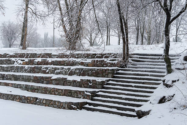 istock Snow-covered stone staircase leading through winter landscape. 2245354982