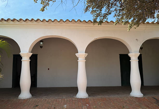 istock Spanish colonial architectural gallery with white stucco columns and arches - Hacienda-style terrace on a sunny day 2245356349