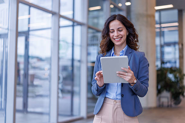 istock Businesswoman standing in modern office using digital tablet 2245358291