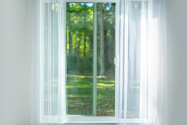 istock Bright window with sunlight. Modern home interior view. White curtains at home. Peaceful window with garden view. Minimalist bright window. Window with sheer drapes. Calm sunlight in cozy room. 2245359445