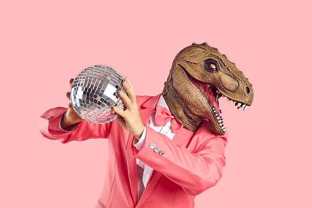 istock Man in rubber dinosaur mask gold disco ball 2245361048