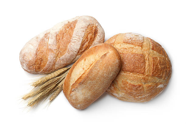 istock Different types of bread and wheat spikes isolated on white, top view 2245365636