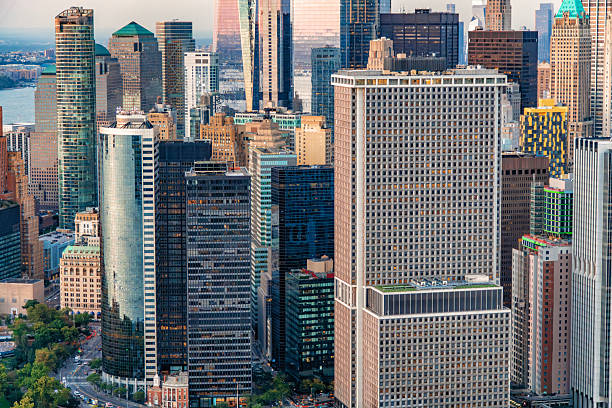 A high angle view at dusk across multiple office and apartment buildings in Manhattan, New York City.
