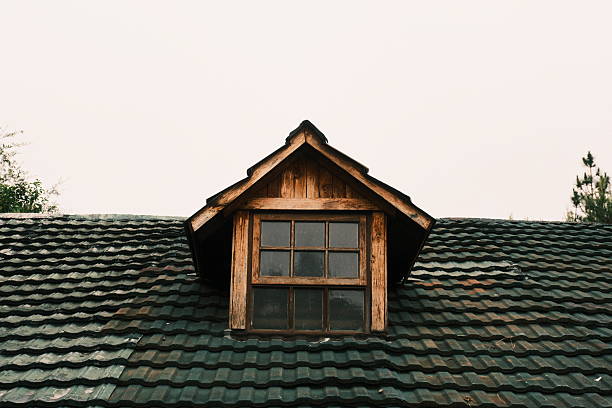 istock Rustic Wooden Dormer Window on Tiled Roof 2245370031