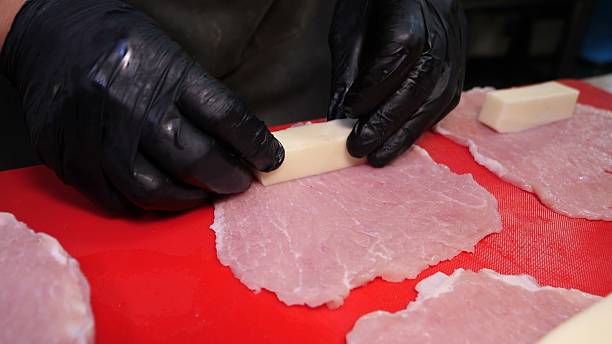 istock Raw meat slices wrapped around cheese blocks for culinary prep 2245370473