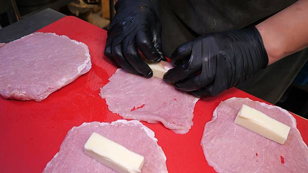 istock Raw meat slices wrapped around cheese blocks for culinary prep 2245370484