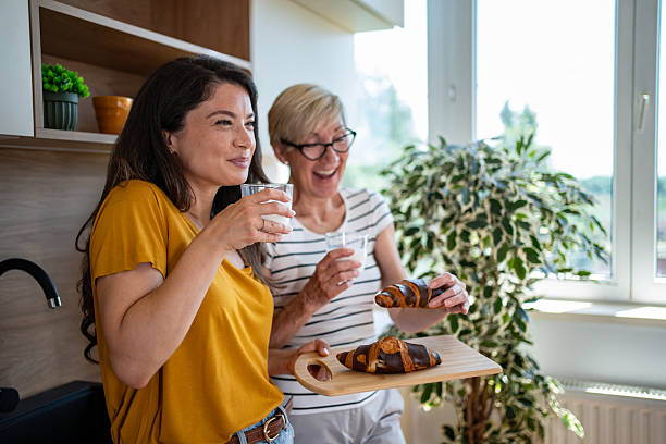 istock Mother and daughter enjoying breakfast together in kitchen 2245370787