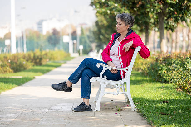 Beautiful woman sitting on park bench