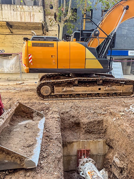 istock Excavator Working on Urban Construction Site with Deep Trench 2245373181