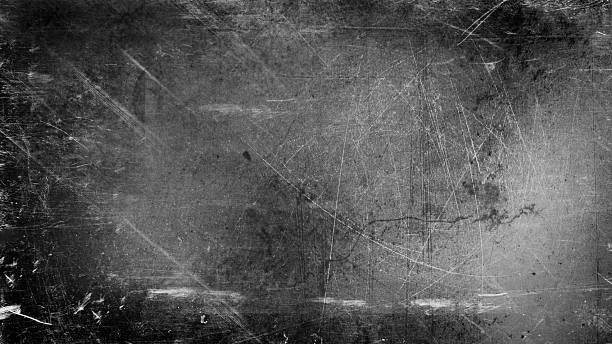 istock Abstract blurred grainy background with light and black scratches on gray. 2245373262