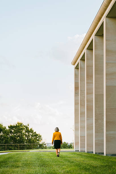 Mature businesswoman walks in large office park
