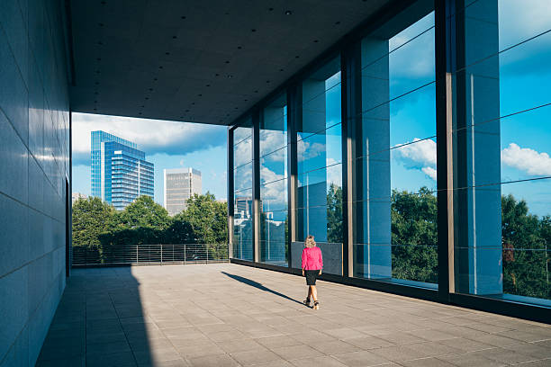 Mature businesswoman walks in large office park