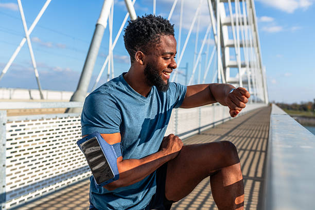 istock Smiling athlete checking smartwatch during outdoor workout 2245373883