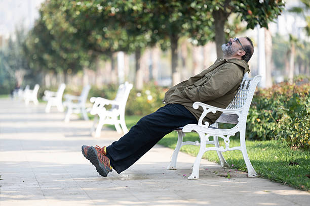 A man having fun outside in the park and using smart phone