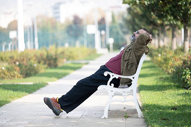A man having fun outside in the park and using smart phone
