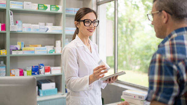 istock Pharmacist advising customer about medication at drugstore counter 2245376308
