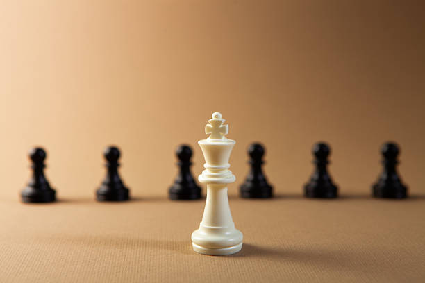 istock white chess figure with black pawn on a chessboard on the chessboard. 2245376419