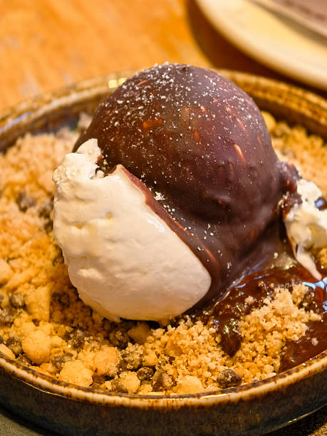 Delightful dessert featuring ice cream and chocolate sauce on crumbled cookies