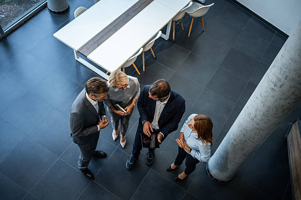 istock Business team collaborating standing in modern office 2245376866