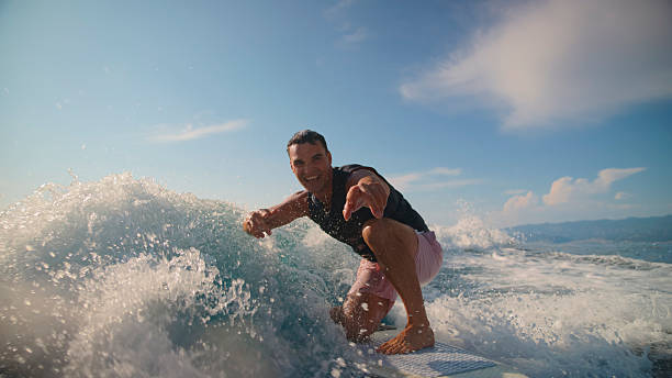 istock Caucasian Man Wake Surfing Behind Boat on Clear Day 2245377248