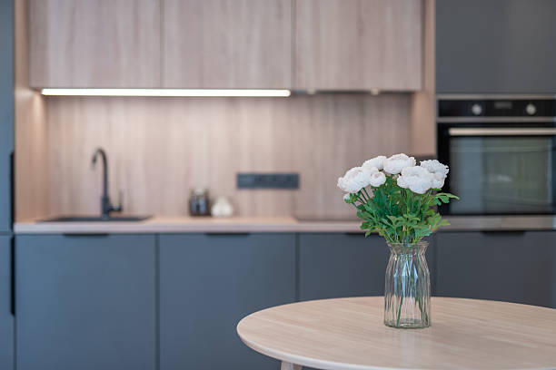 istock Modern Home Kitchen Interior with Floral Centerpiece on Wooden Table 2245377364