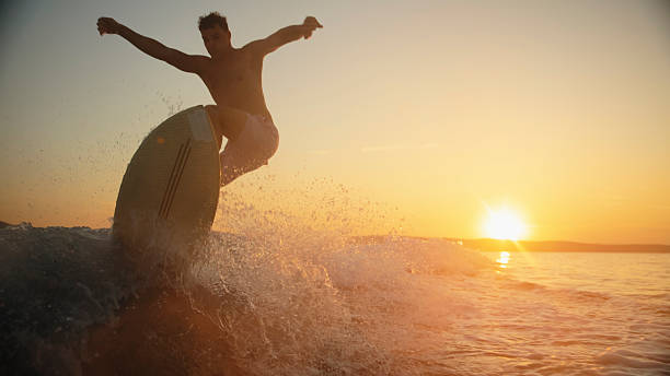 istock Sunset Wake Surfing with Young Caucasian Male 2245377374
