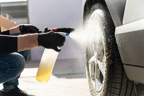 istock Person detailing car wheel with spray bottle 2245377742