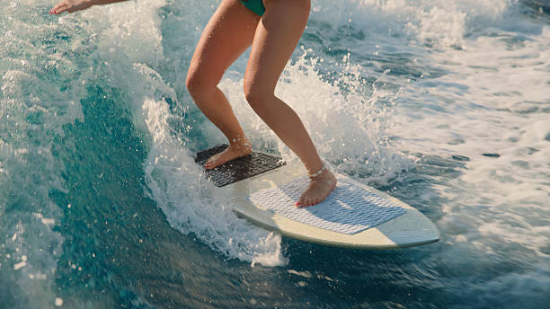 istock Woman Surfing on Ocean Wave with Water Splashing 2245377929