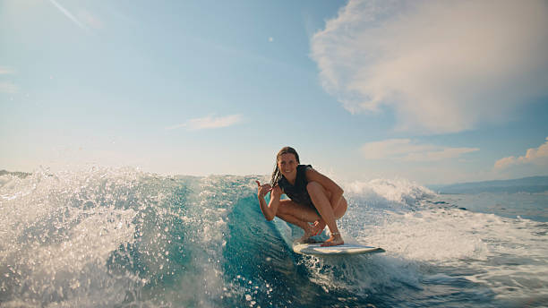 istock Young Caucasian Woman Surfing on Ocean Wave 2245377940