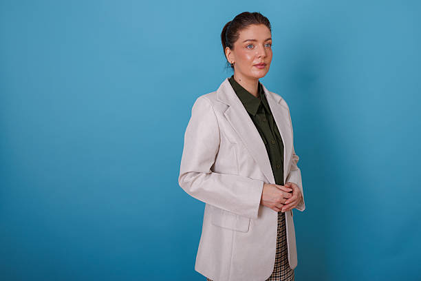istock Businesswoman looking forward with confidence against a blue background, planning future success 2245378225