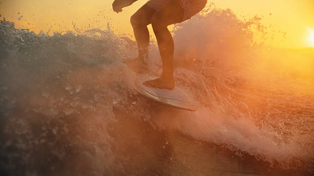 istock Sunset Wakeboarding with Young Caucasian Male on Water 2245378333