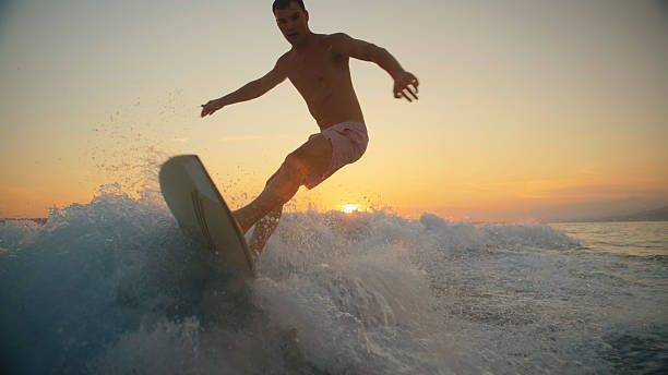 istock Caucasian Man Riding Wake at Sunset 2245378358