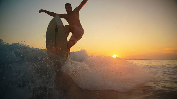 istock Sunset Surfing with Young Caucasian Male on Wake 2245378370