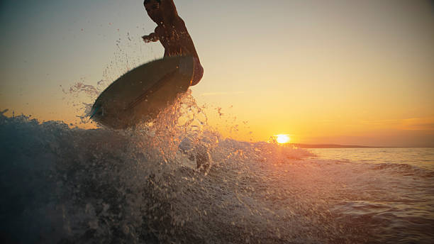 istock Caucasian Man Wake Surfing at Golden Hour 2245378374