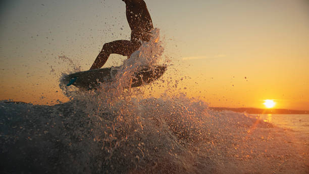 istock Caucasian Male Wake Surfing at Sunset on Ocean 2245378375
