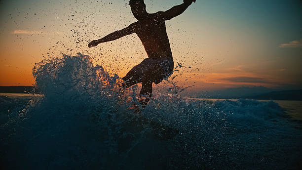 Wild, huge waves with a surfer breaking in the turquoise Atlantic Ocean in sunny weather