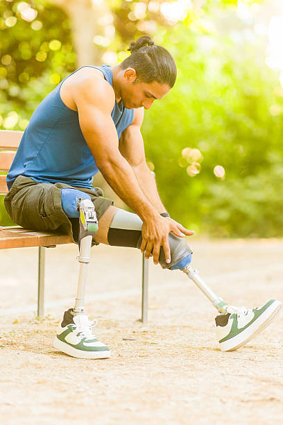 istock Male athlete with prosthetic legs resting in park 2245379630