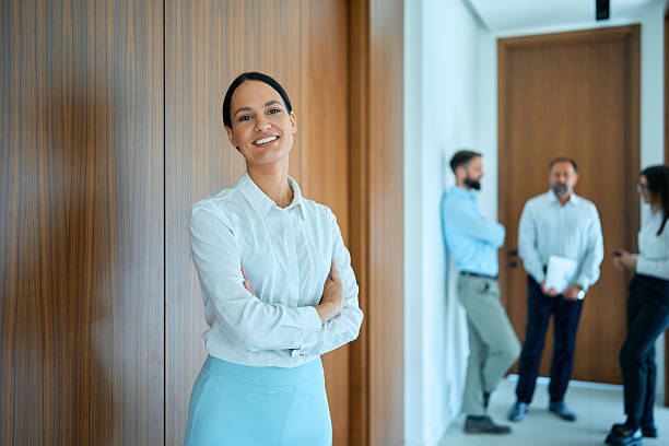 istock Professional businesswoman smiling in modern office hallway 2245383309