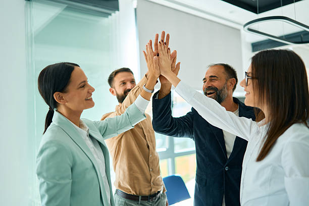istock Diverse business team celebrating success giving high five 2245383405