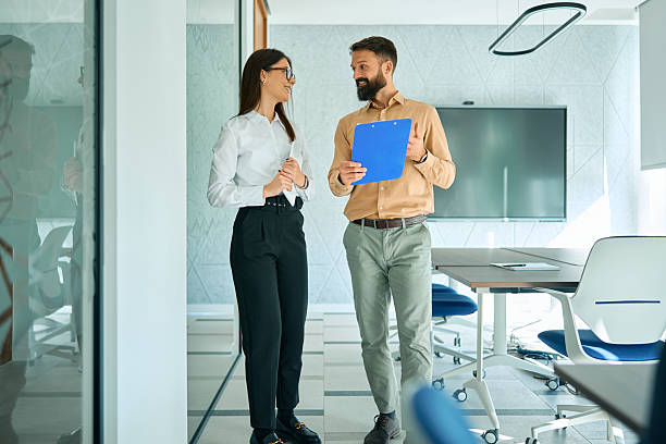 istock Business colleagues discussing project while standing in modern office 2245383483