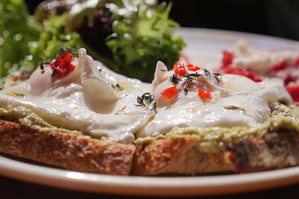 Delicious avocado toast featuring poached eggs and colorful toppings.