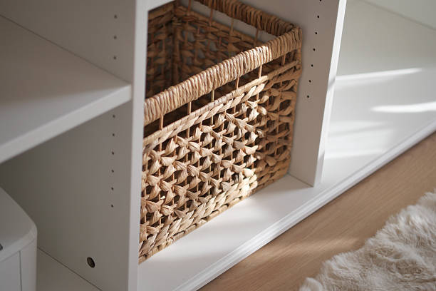 istock Natural woven basket in a modern white shelf setup 2245385405