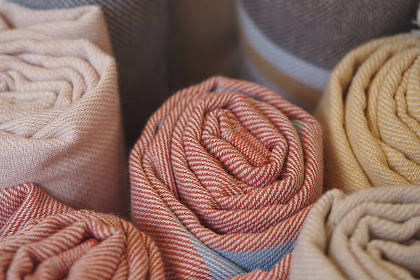 Close-up on blanket covering human's feet on bed.